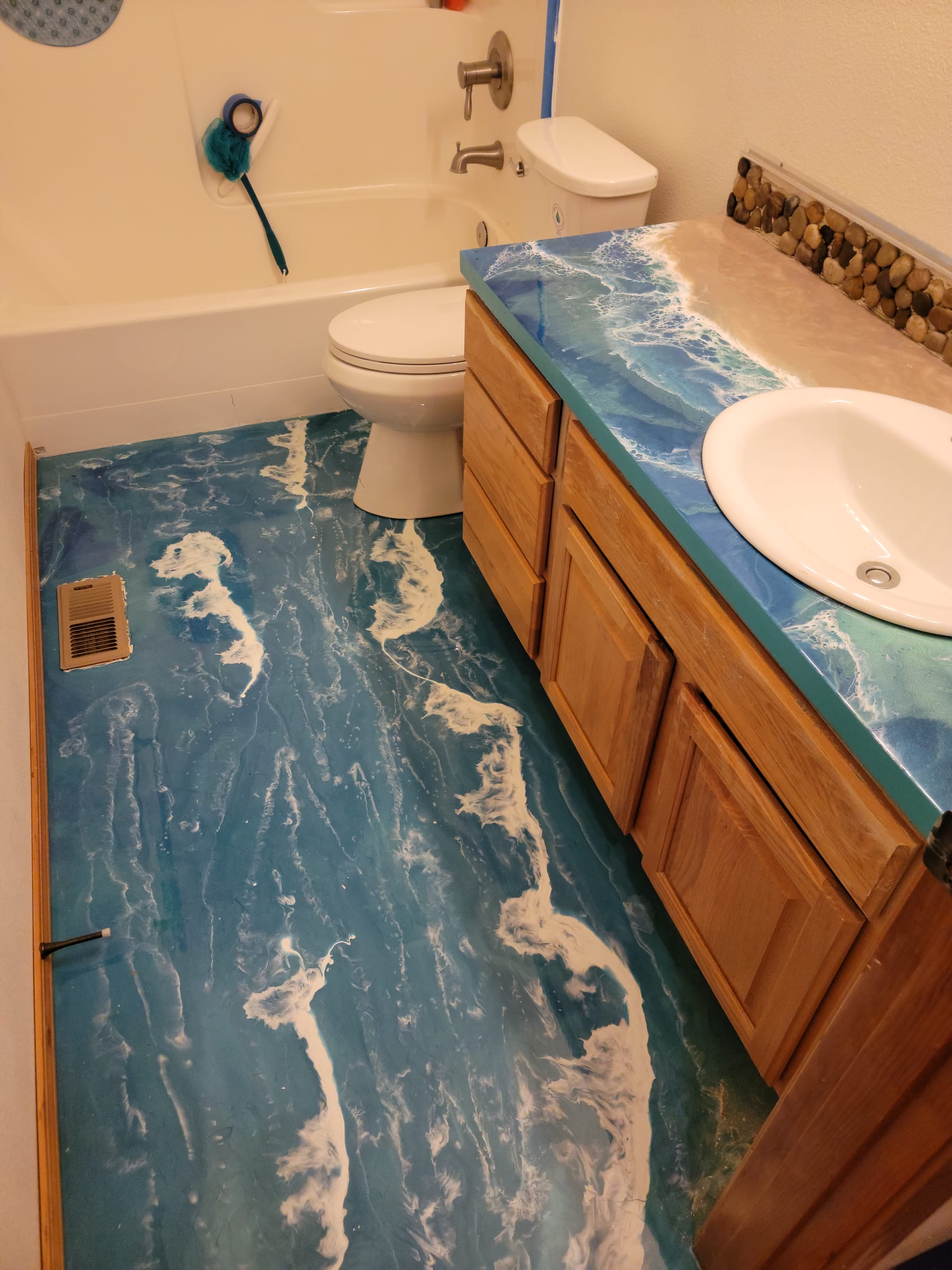 Bathroom with matching ocean wave epoxy vanity and floor by Ray Sample, Castle Rock CO