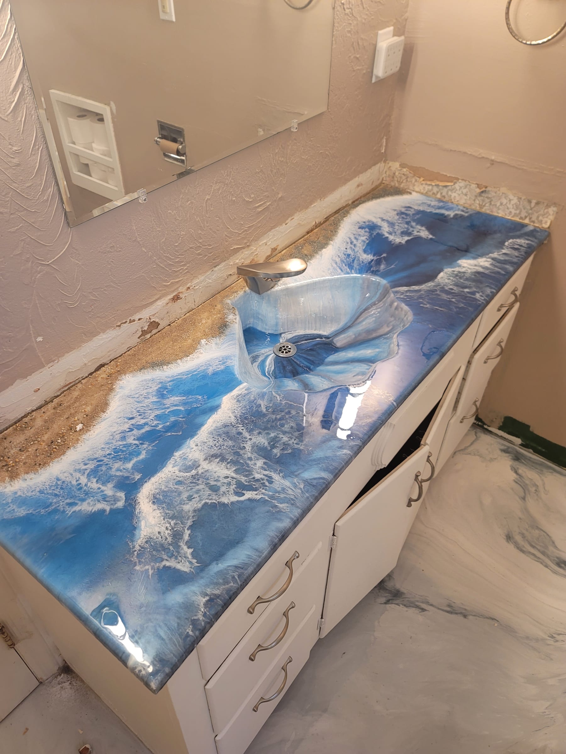 Epoxy bathroom vanity with integrated shell-shaped sink and ocean wave pour by Ray Sample