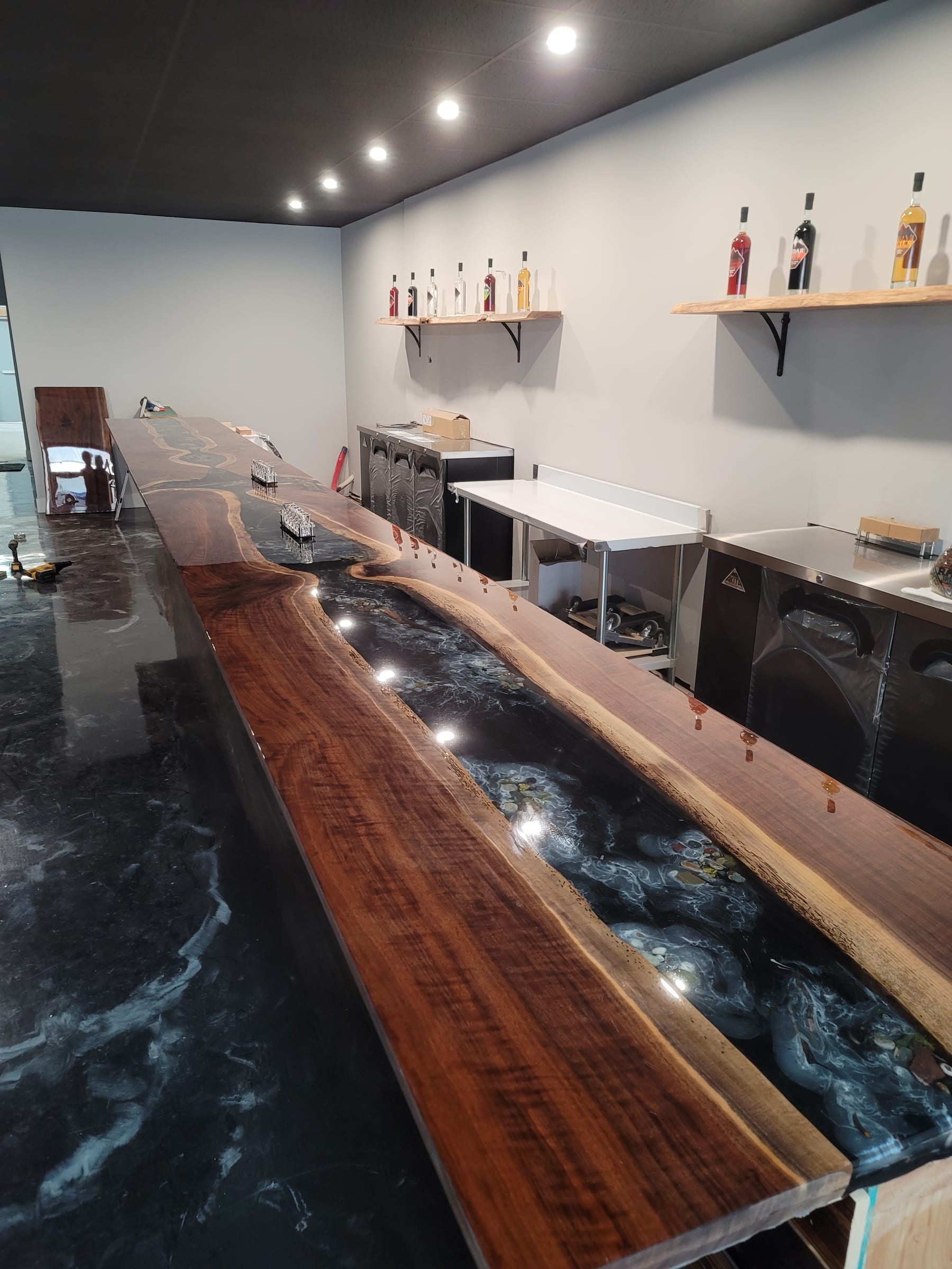 Long walnut bar top with embedded river stones in epoxy resin by Ray Sample, Castle Rock CO