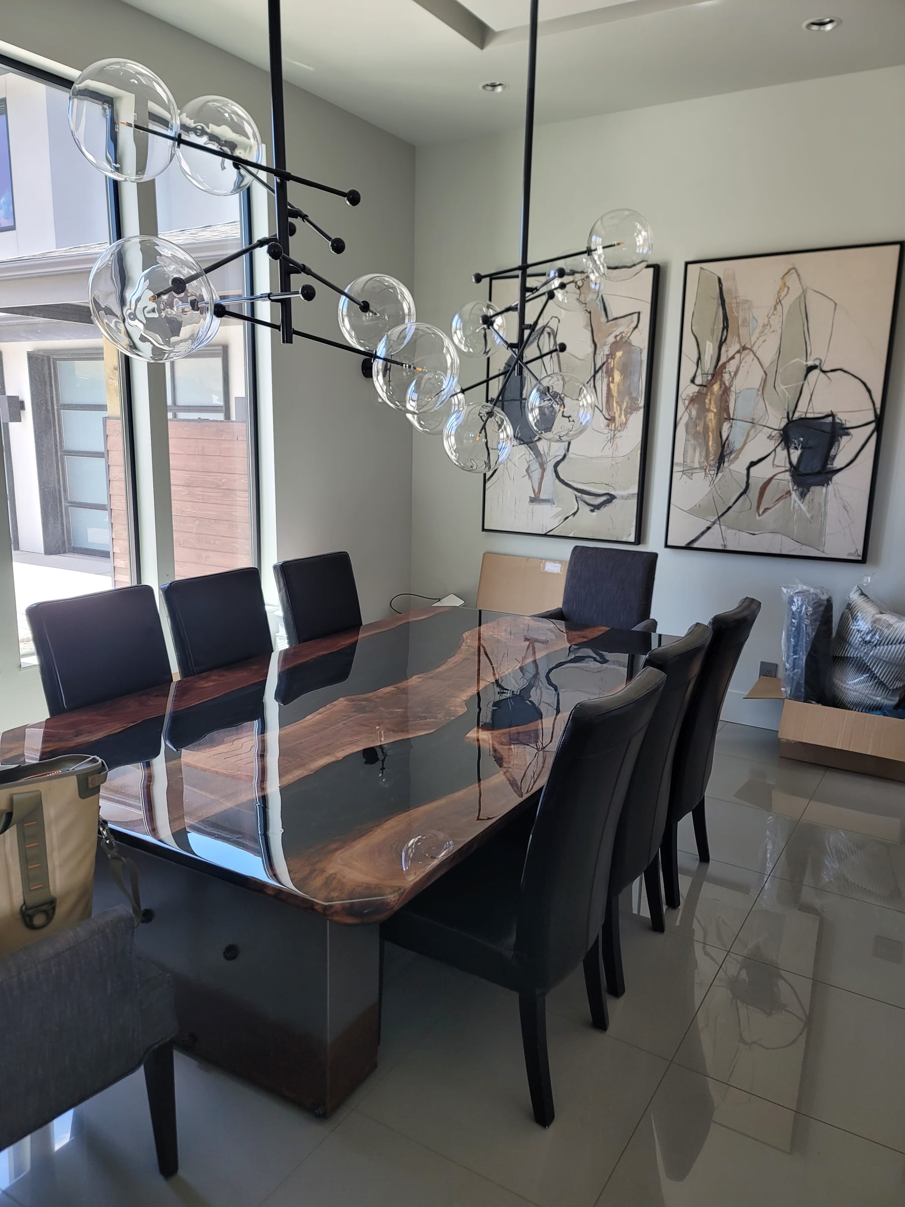 Walnut river dining table with smoked resin installed in a modern Denver home, by Ray Sample