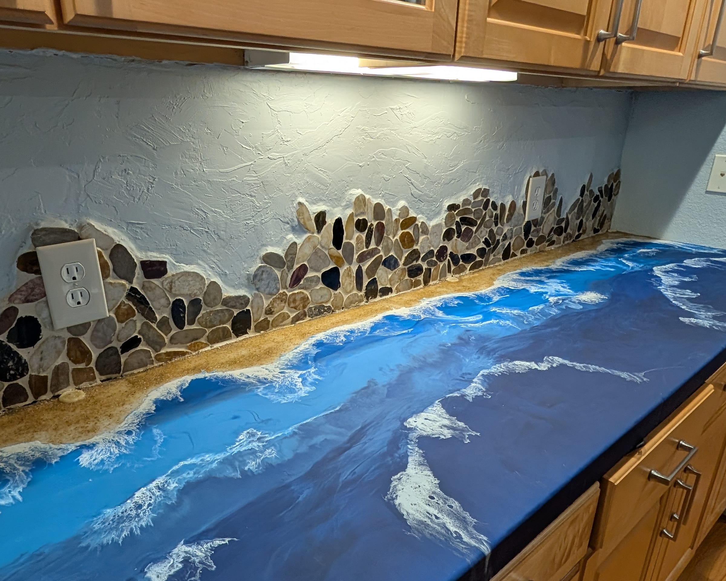 Hand-built river-rock and ocean resin wall feature by Ray Sample, Castle Rock CO